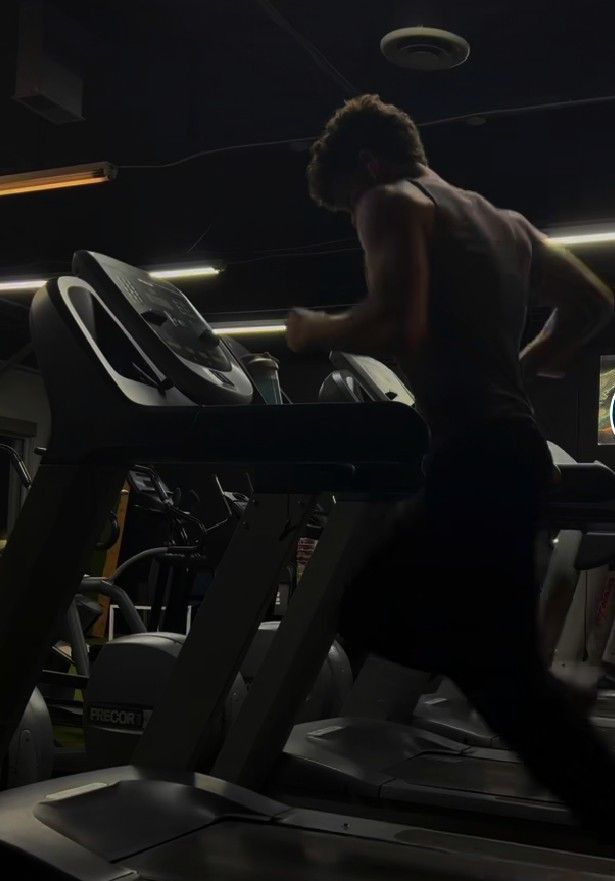 a man running on a treadmill in a gym