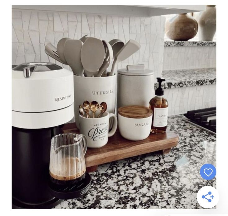 the kitchen counter is clean and ready to be used as a coffee maker, sugar dispenser, measuring spoons and cups