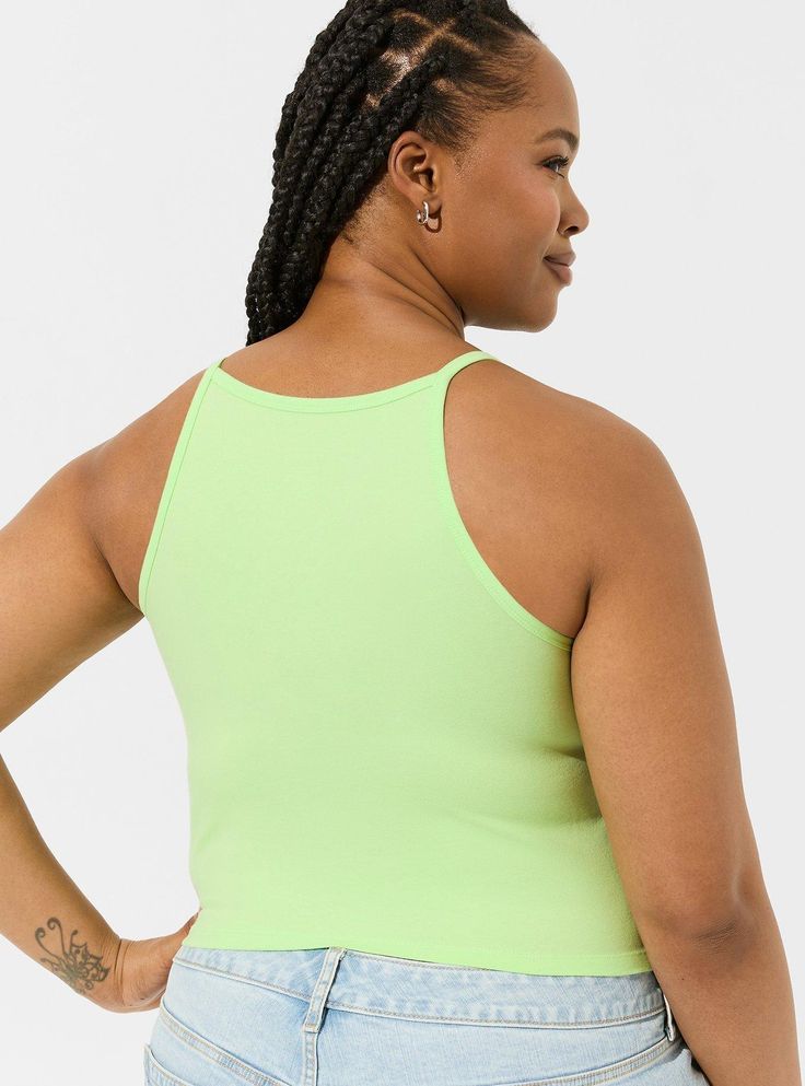 You'll love the versatility and flattering fit of a Foxy crop top that's thick with just the right amount of stretch. Foxy fabric. High neck. Racerback. Sleeveless; fixed straps. Cropped. CONTENT + CARE Cotton/spandex. Wash cold; dry low. Imported plus size tops. SIZE + FIT Model is 5’10. 5”, size 1. Size 2 measures 21” from shoulder. The best plus size women's foxy high neck crop top camis in paradise green made of foxy. Rock your look from Torrid to Festivals like Coachella and Lollapalooza, a Fitted Cami Crop Top In Athleisure Style, Fitted Cami Crop Top Athleisure, Sports Crop Top With Adjustable Straps, Sporty Cropped Tops With Adjustable Straps, Spring Cropped Sports Bra With Medium Support, Stretch Elastane Tank Halter Top, Sleeveless Elastane Sports Bra For Summer, Stretch Elastane Halter Tank Top, Sporty Cami Crop Top With Seamless Construction