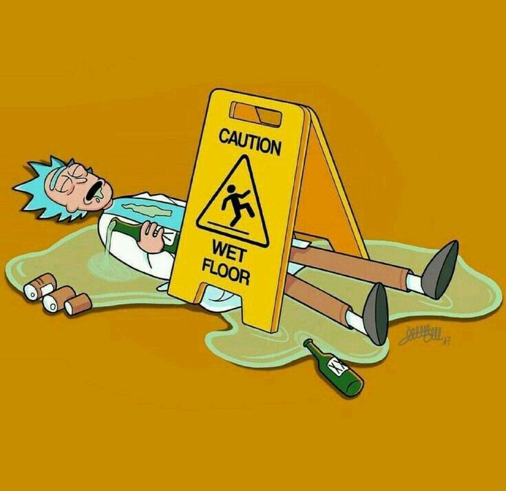 a cartoon character laying on the ground next to a caution wet floor sign