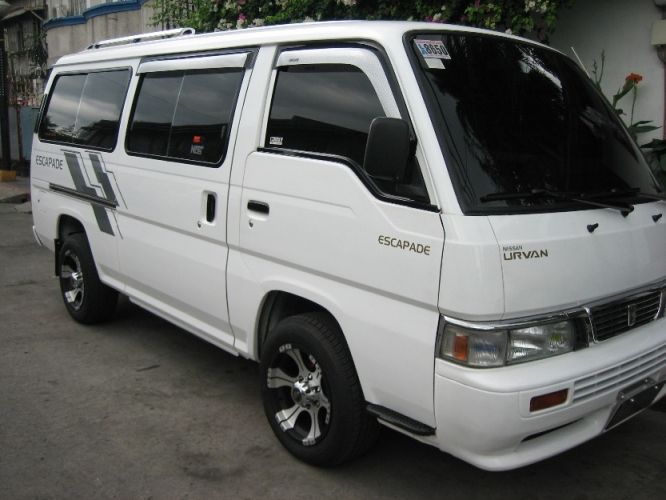 a white van parked in front of a building