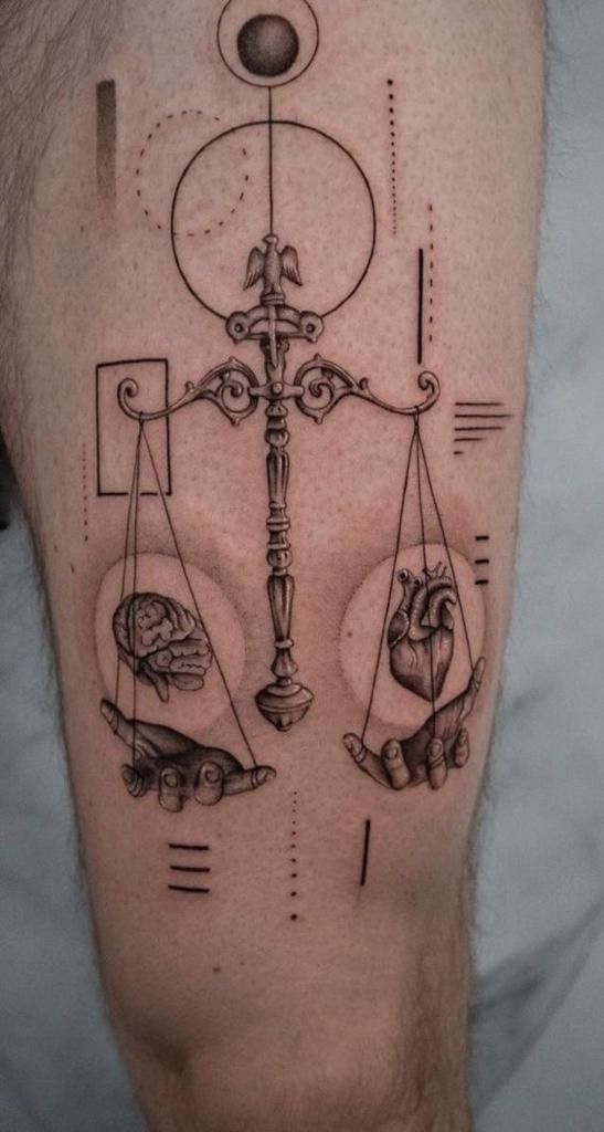 a man's leg with a tattoo on it that has an image of two hands holding