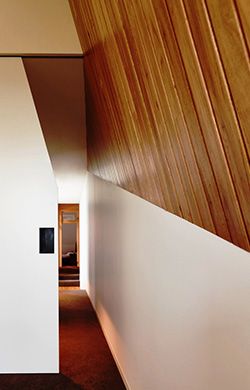 the interior of a house with wood paneling and white walls