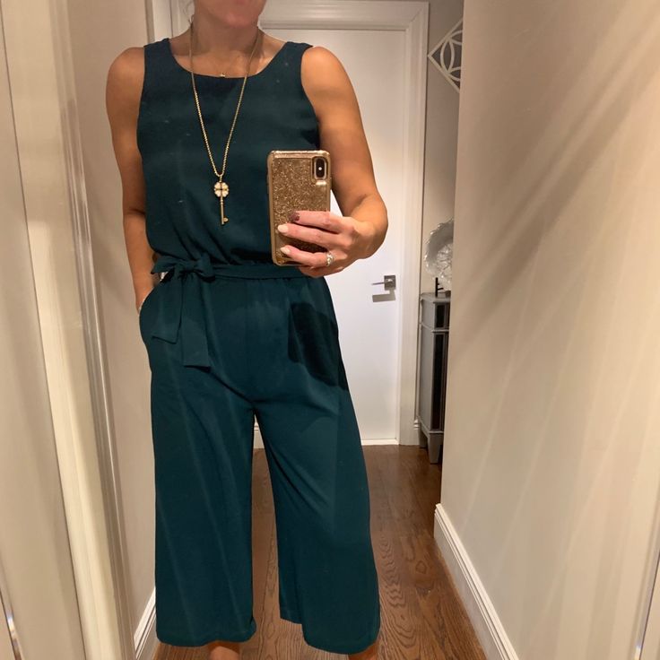 This Jumpsuit Is So Versatile. Dress Up Or Down W/Flats, Heels, Boots Or Sneakers. Wear A Chic Long Blazer On Top For An Instant Upgraded Look!!Color Is A Teal/Green. Chic Sleeveless Jumpsuits And Rompers With Tie Waist, Elegant Sleeveless Tie Waist Jumpsuits And Rompers, Green Tie Waist Jumpsuit For Work, Sleeveless Green Jumpsuits And Rompers For Work, Sleeveless Workwear Jumpsuit With Tie Waist, White Denim Jumpsuit, Oversized Jumpsuit, Animal Print Jumpsuit, Zara Floral Dress