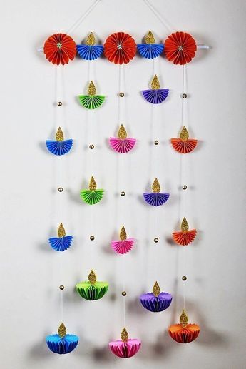 colorful paper fans are hanging on the wall