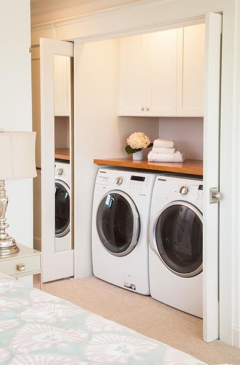 there is a washer and dryer in this small room with the door open