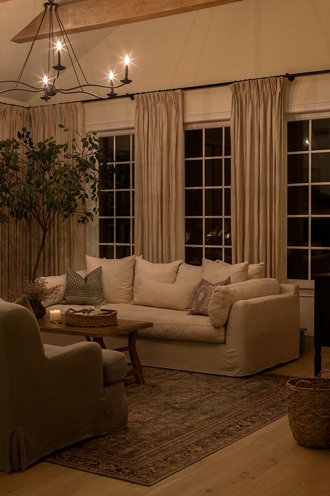 a living room filled with furniture and windows