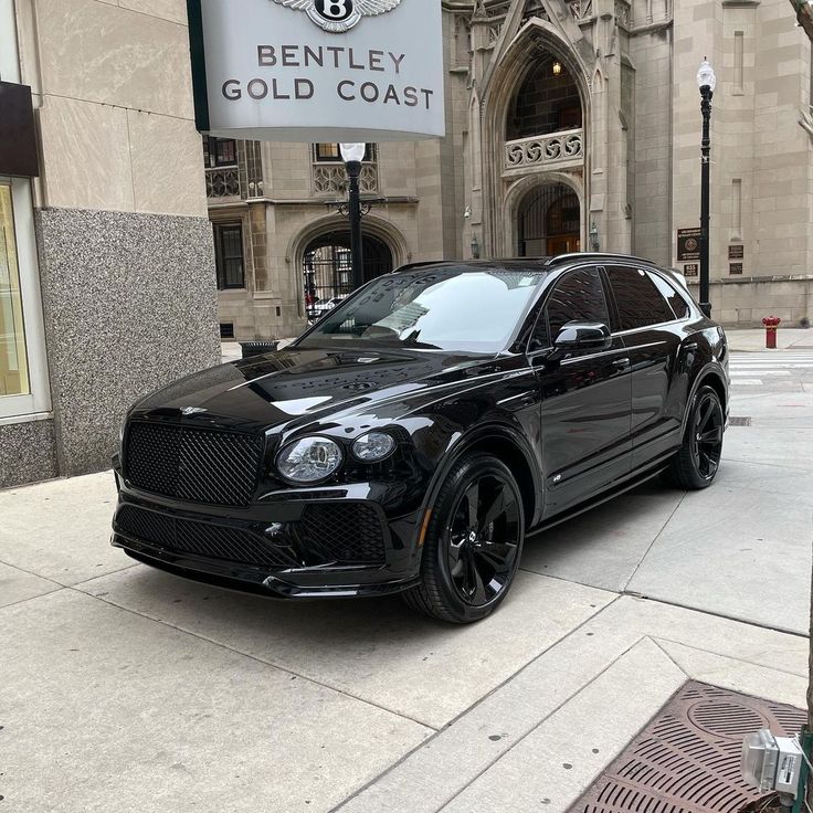 a black car is parked in front of bentley's gold coast