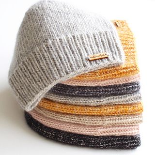 a pile of knitted hats sitting on top of each other