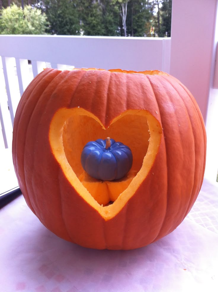 a pumpkin carved to look like a heart