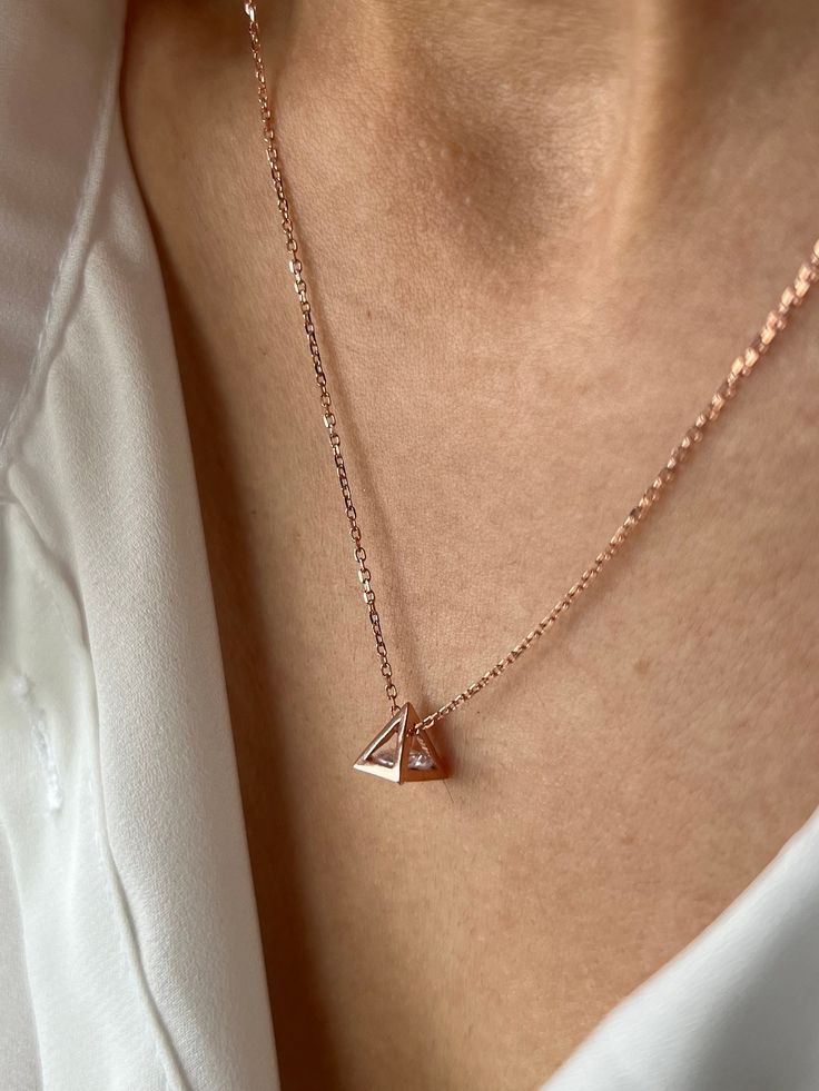 Beautiful pyramid necklace with a diamond shape stone inside △ Get this beautiful minimalist jewelry made with the quality of perfect elements✨ You can choose 925K Sterling Silver with the options of Gold, Rose Gold or White Gold colors. High quality jewelry for everyone 🤍  Details * 925K Sterling Silver Option → 14K Gold, Rose Gold or White Gold plated * Chain length is approximately 18 inches (16+2 in extender) / 45 cm (40+5 cm extender) * Time is everything! You will receive your package as soon as possible 🚚  * We care about the quality of metal to make sure it will last for a long time * We use enamel technique to color the jewelry and high quality zircons only * There can be tiny differences on each item. Length difference of the chain as well as color changes and shade differences Minimalist Diamond-shaped Everyday Jewelry, Minimalist Everyday Diamond-shaped Jewelry, Everyday Minimalist Diamond-shaped Jewelry, Minimalist Diamond-shaped Jewelry In Diamond White, Minimalist Rose Gold Diamond Charm Necklace, Elegant Triangle Everyday Jewelry, Pyramid-shaped Sterling Silver Jewelry Gifts, Sterling Silver Pyramid Jewelry As Gift, Sterling Silver Pyramid Jewelry For Gifts