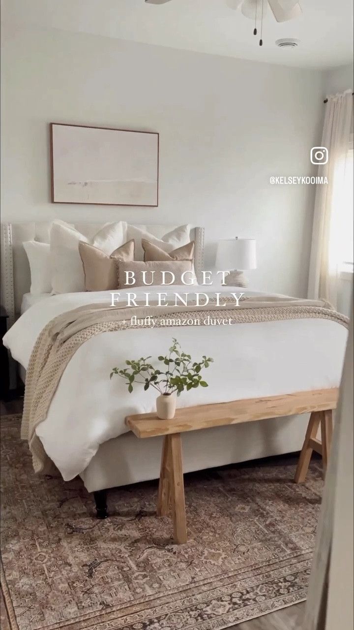 a white bed sitting in a bedroom next to a wooden foot board on top of a rug