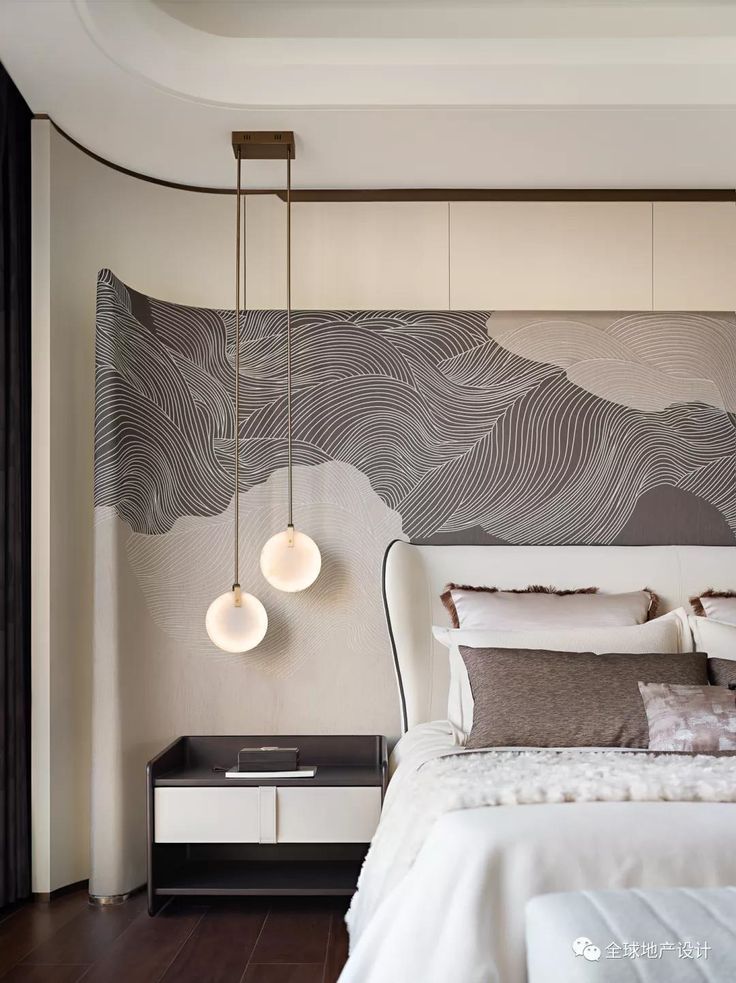 a bed with two lamps hanging from it's headboard