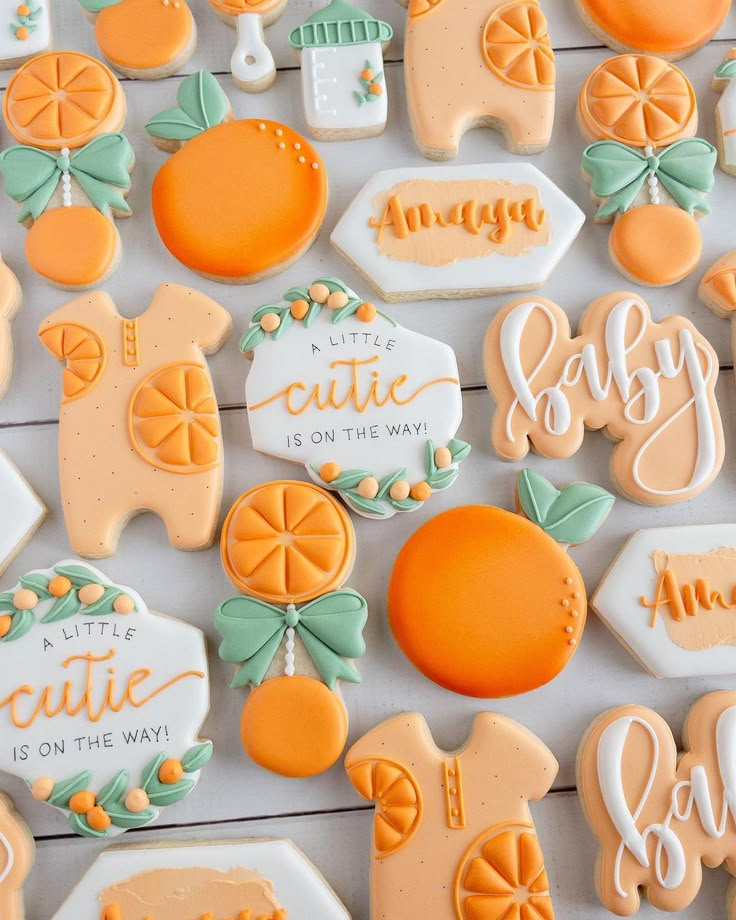 decorated cookies are arranged on a table for a baby's first birthday party or celebration