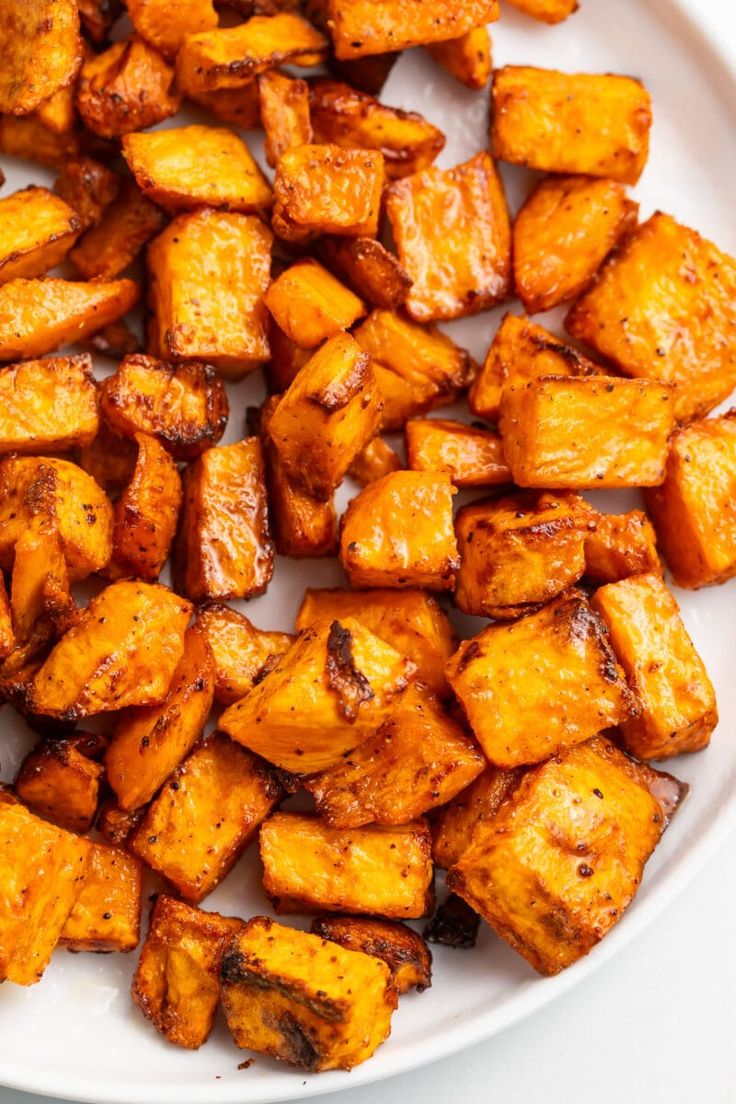 a white plate topped with cooked sweet potatoes