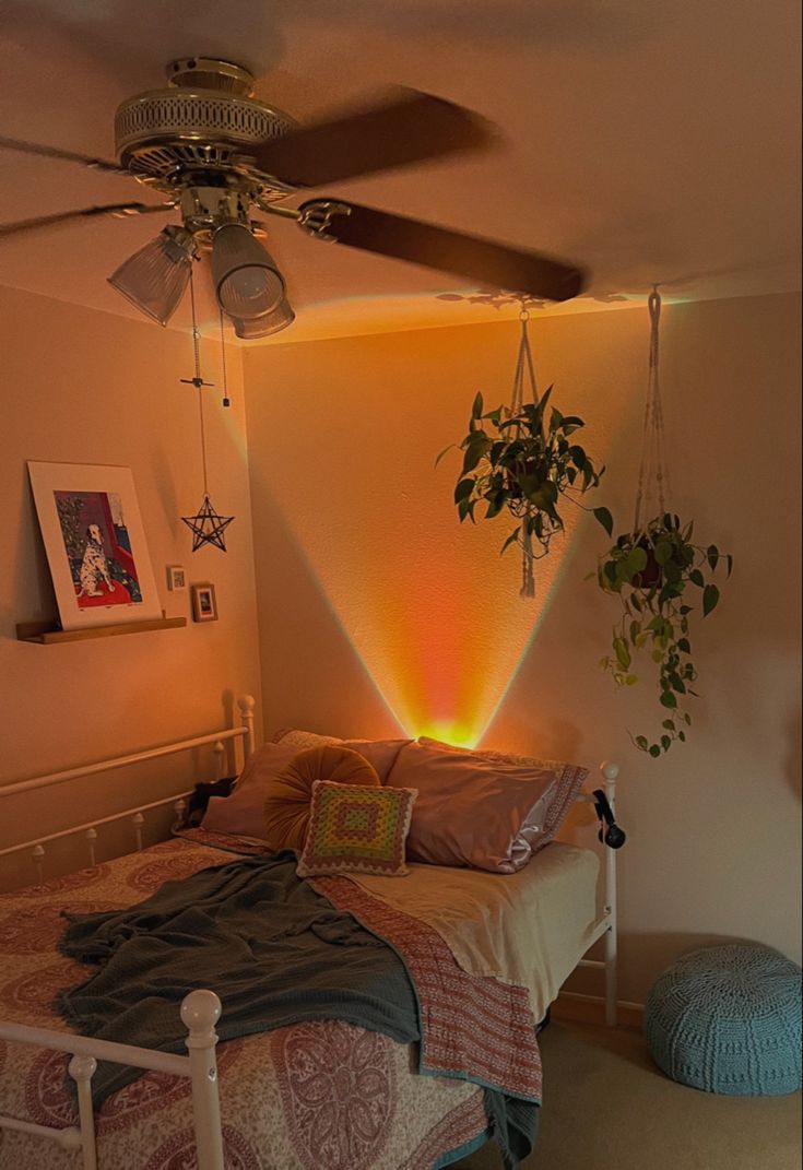 a bed room with a neatly made bed and a fan on the wall above it