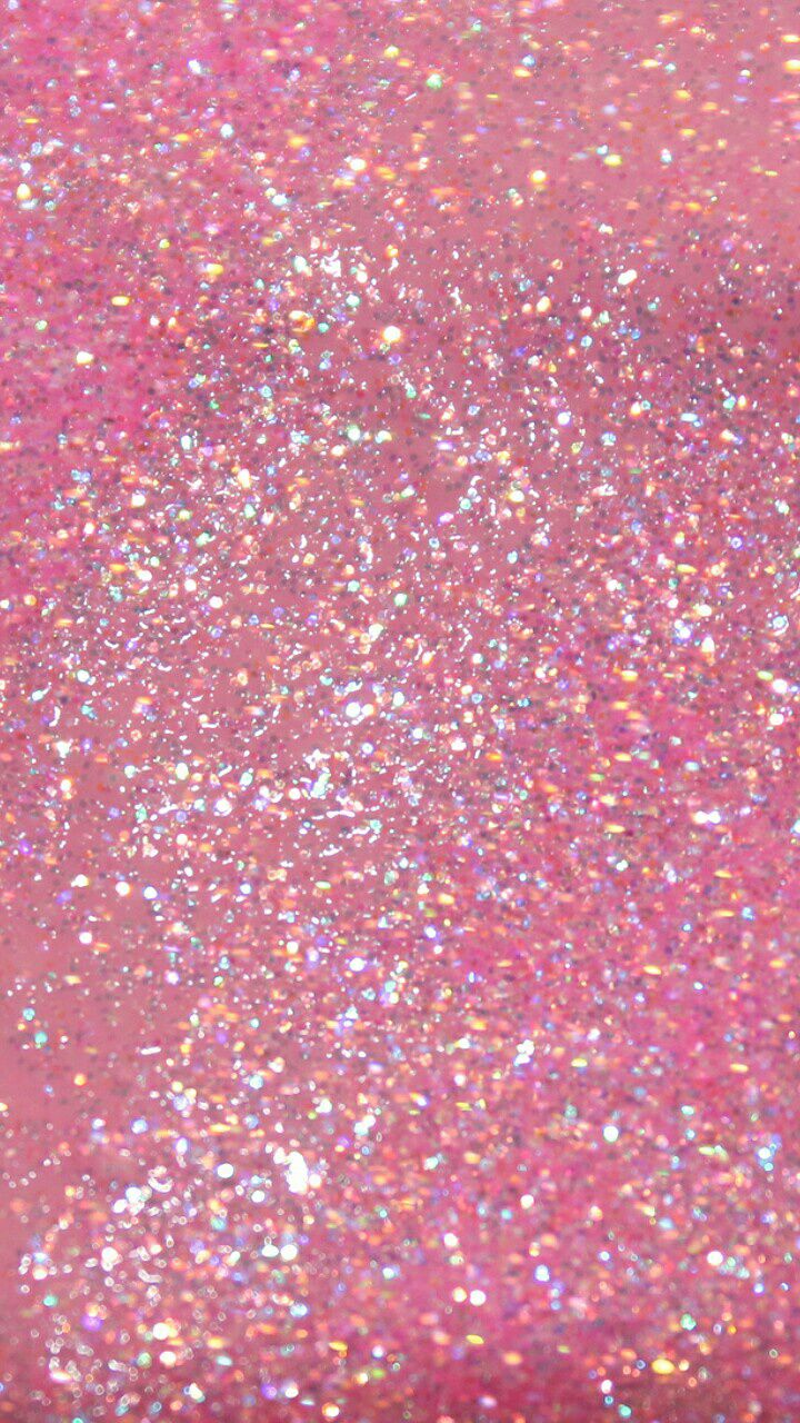 a pink glitter background with lots of small sparkles