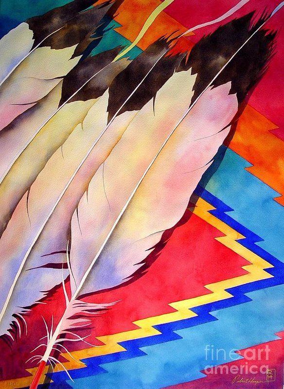 some feathers are laying on a colorful cloth