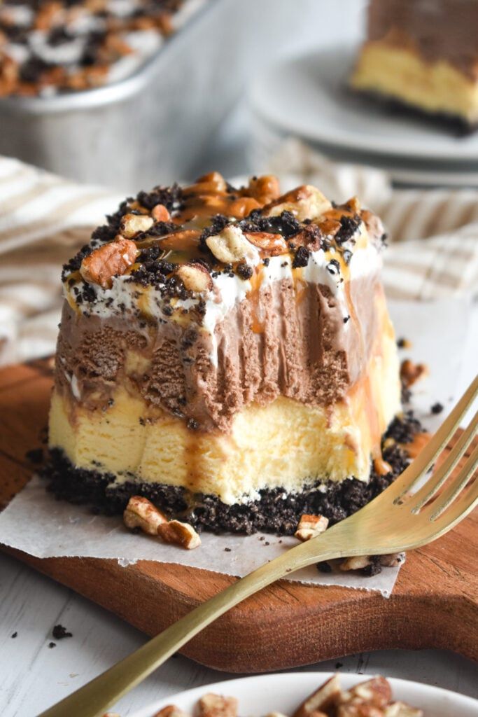 a piece of cake sitting on top of a wooden cutting board next to a fork