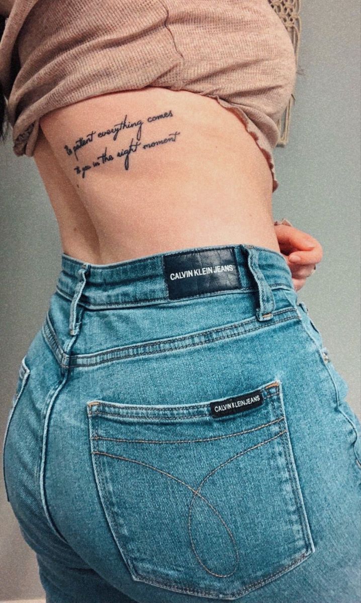 the back of a woman's stomach with writing on it