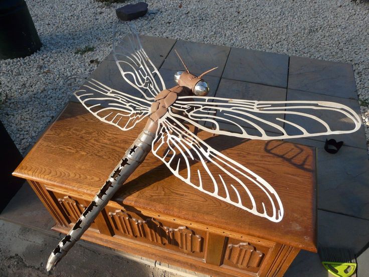 a dragonfly sitting on top of a wooden box