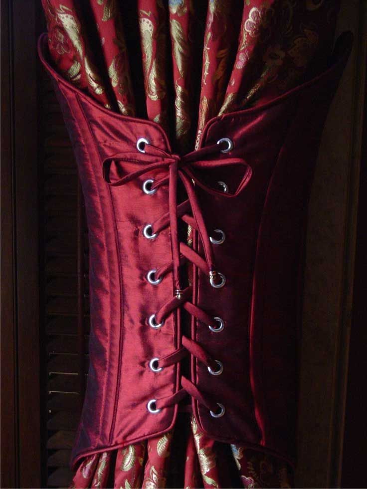 a red corset with gold brocades on it