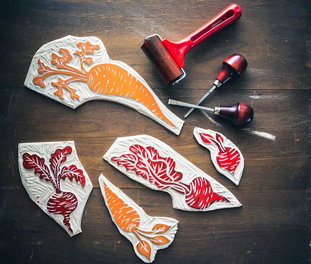 some cut out carrots are sitting on a wooden table next to a pair of scissors