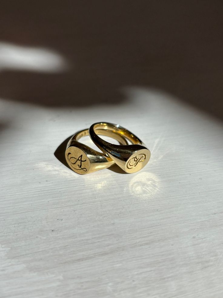 Hand carved signet ring with custom letter engraving. Perfect as a gift to a loved one, yourself, or both! These rings are modern in their deisgn but also have a vintage feel through the handwritten engravings.  Originally, I created these rings for my partner and I for our anniversary. I hand carved the signet ring from scratch out of wax, engraved the letters and our date into the wax ring, and cast them into brass. These are available to be made custom with any letter and in any metal!  **Ins Engraved Oval Symbolic Signet Ring, Personalized Adjustable Symbolic Signet Ring, Adjustable Personalized Symbolic Signet Ring, Adjustable Symbolic Personalized Signet Ring, Vintage Initial Ring For Anniversary, Vintage Stamped Initial Ring For Anniversary, Symbolic Engraved Signet Ring For Wedding, Symbolic Formal Engraved Ring, Symbolic Signet Ring With Initials