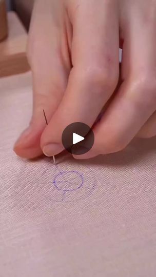 someone is doing something with their thumbnails on the paper and needles in front of them