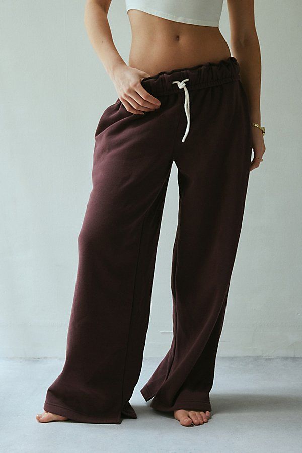 Out From Under sweatpant made special with piping details. Designed in a relaxed wide-leg silhouette featuring a ruffled elastic waistband with drawstring tie, side pockets and split hems. Exclusively at Urban Outfitters. Features Out From Under Hoxton piping wide leg sweatpant Wide leg sweatpant Soft and stretchy knit Ruffled elastic waistline with drawstring tie Side pockets with contrast piping down the sides Split hems Relaxed wide-leg fit Full length Easy pull-on style UO exclusive Content Gifts For Boyfriend Clothes, Proclub Sweats, Staple Clothing Pieces, Cool Sweatpants, Brown Sweatpants, Fall Bottoms, Garage Clothing, Urban Outfitters Clothes, Trendy Pants