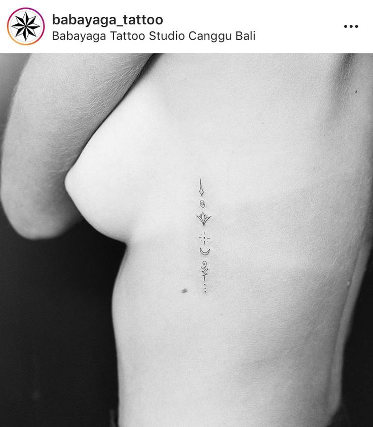 the back of a woman's stomach with three small tattoos on her left side