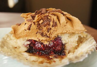 a piece of cake on a plate with peanut butter and cranberry toppings