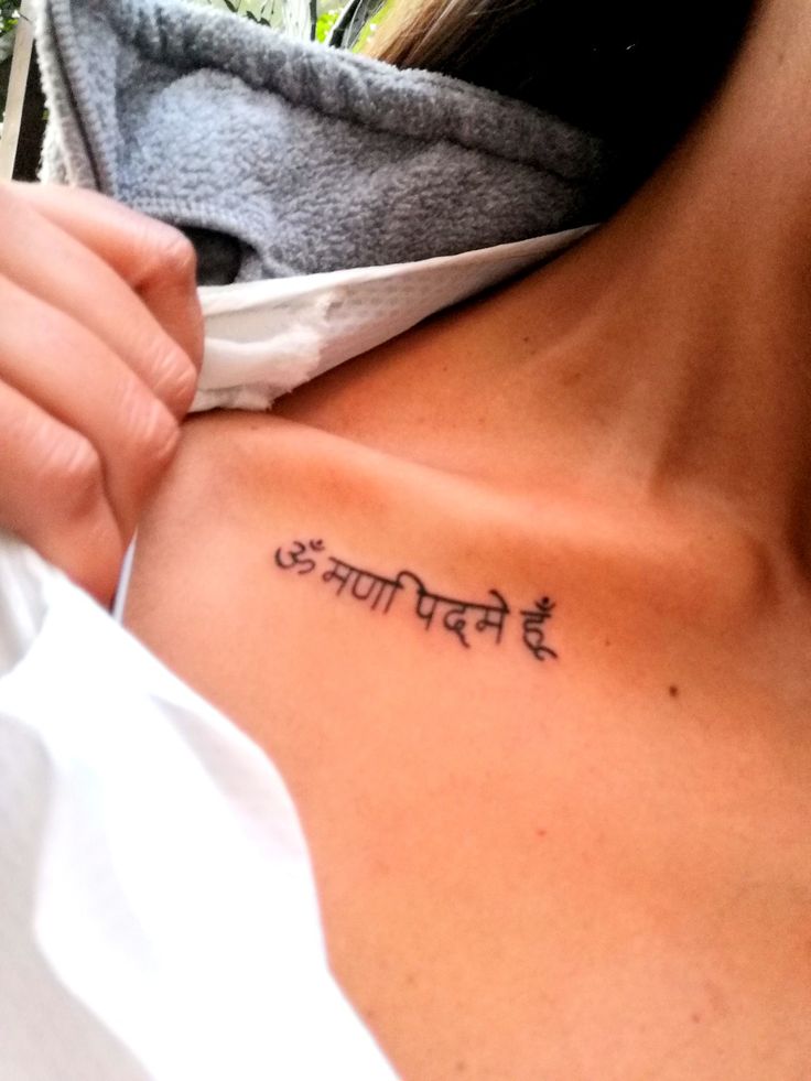 a woman with a small tattoo on her chest