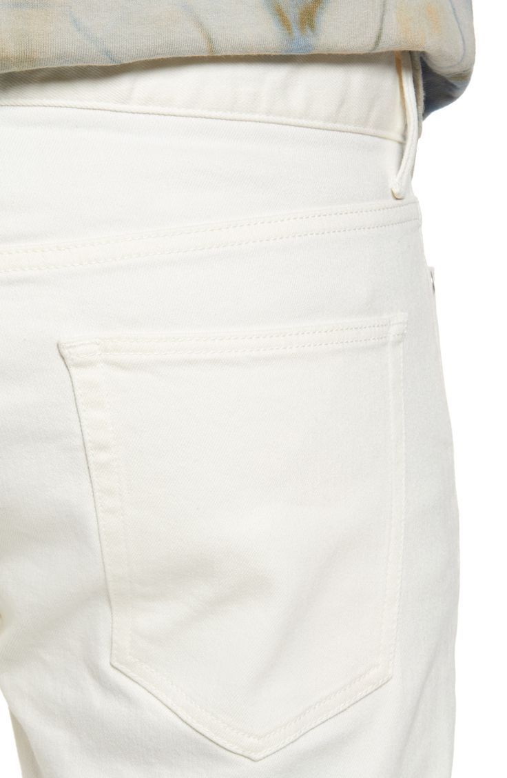 Crisp white Japanese-denim jeans are cut in a skinny fit with a hint of stretch that allows you to move freely and comfortably in these five-pocket jeans. 32 1/2" inseam; 13" leg opening; 10 1/2" front rise; 14" back rise (size 32) Zip fly with button closure Five-pocket style 98% cotton, 2% polyurethane Machine wash, line dry Made in Japan Men's Clothing Fitted Cream Jeans With Five Pockets, Fitted Cream Jeans, Modern White Cotton Jeans, Everyday White Mid-rise Pants, White Slim Fit Bottoms With Straight Hem, White Cotton Straight Fit Bottoms, Modern White Tapered Leg Jeans, Classic Cream Jeans With Five Pockets, White Straight Fit Bottoms With Five Pockets