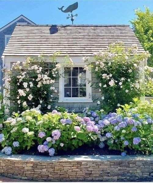 a house with flowers in the front yard