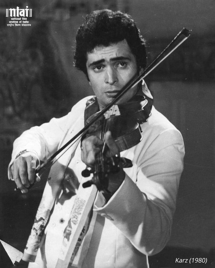 an old photo of a man playing the violin