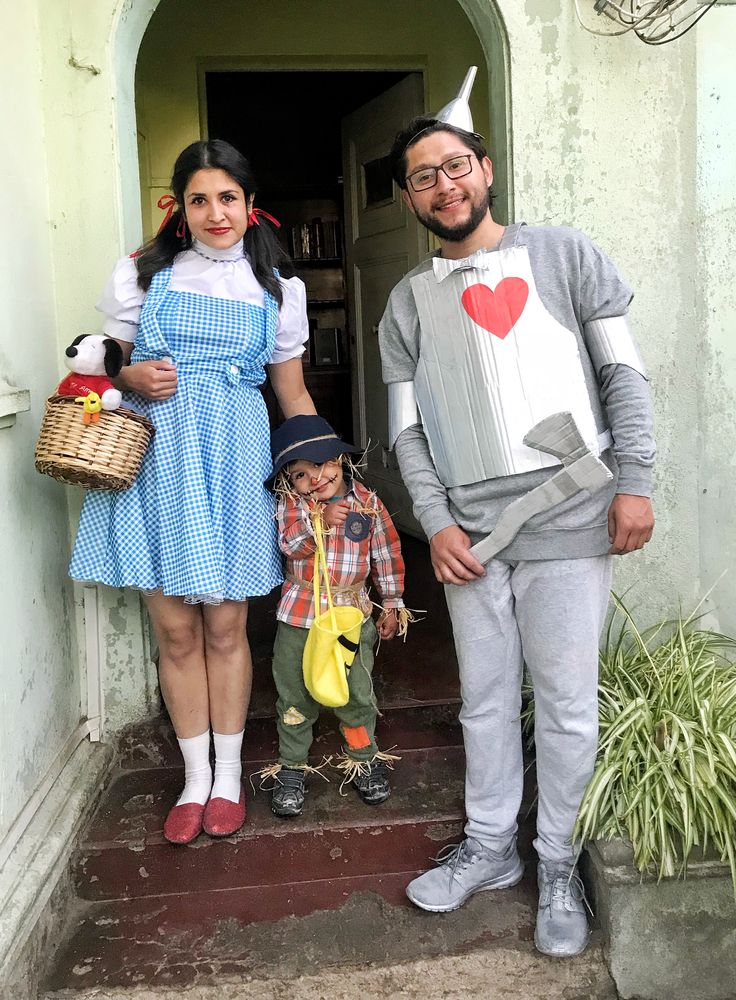 a man and woman in costumes standing next to a child