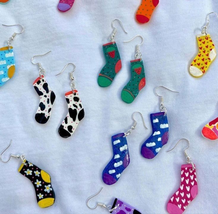 many pairs of colorful socks are hanging from earrings