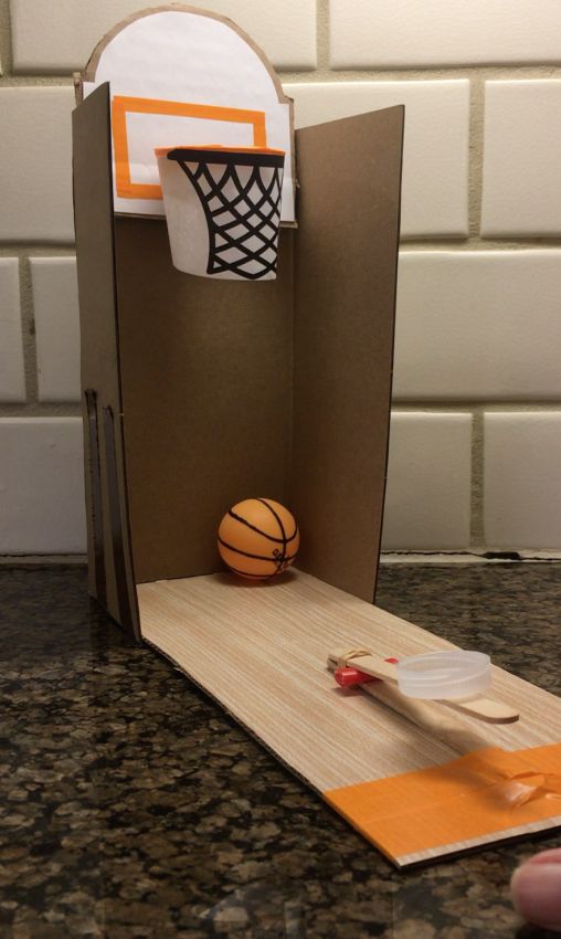 a basketball is in the back of a cardboard box with a basketball on it's side