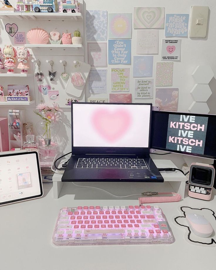 a laptop computer sitting on top of a desk next to a keyboard and mouse pad