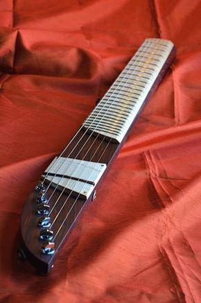 an electric guitar laying on a red sheet