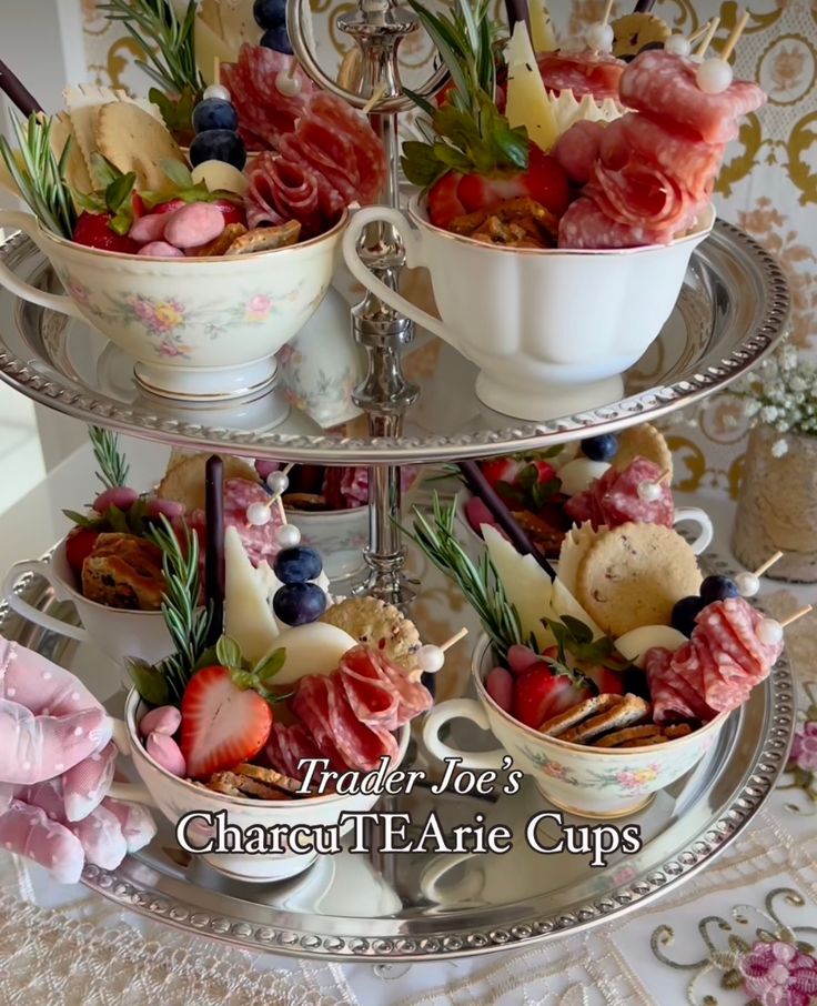 three tiered tray with bowls and cups filled with food