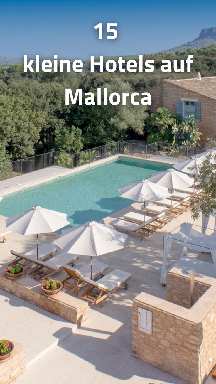 an outdoor swimming pool with lounge chairs and umbrellas