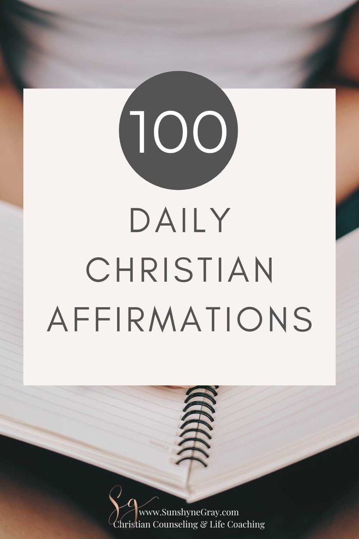 a person holding a notebook with the words 100 daily christian affirmations