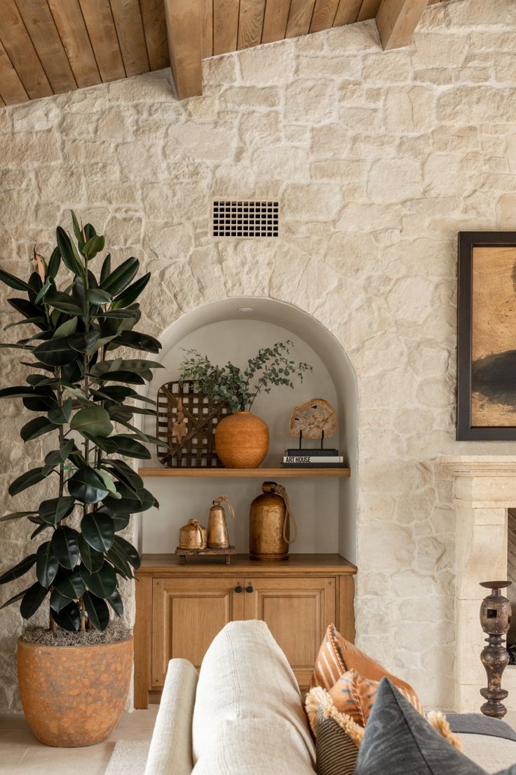 a living room filled with furniture and a potted plant