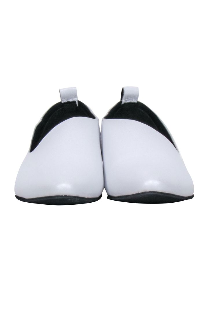 Showcasing All Black's lustworthy white leather flats, a perfect blend of luxury and comfort with their low heel and sophisticated black contrast on the soles and insole. These versatile flats feature a chic, minimal aesthetic, instantly elevating any ensemble. Pair them with high-waisted denim and a silk blouse for a day out or with a flirty dress for a stylish evening rendezvous. Size 6 Leather upper & soles Almond toe Slip-on style Toe to heel 10” Classic White Slip-ons With Flat Heel, White Closed Toe Slip-ons For Office, Modern White Flats With Leather Sole, White Slip-ons With Leather Sole For Office, White Leather Sole Slip-ons For Office, White Synthetic Flats With Low Heel, Classic White Flats With Removable Insole, White Synthetic Low Heel Flats, Classic White Pointed Toe Flats