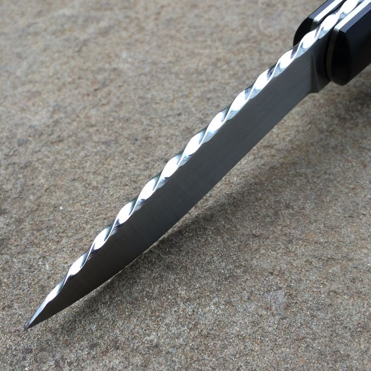 a knife that is laying on the ground with its blade missing from it's end