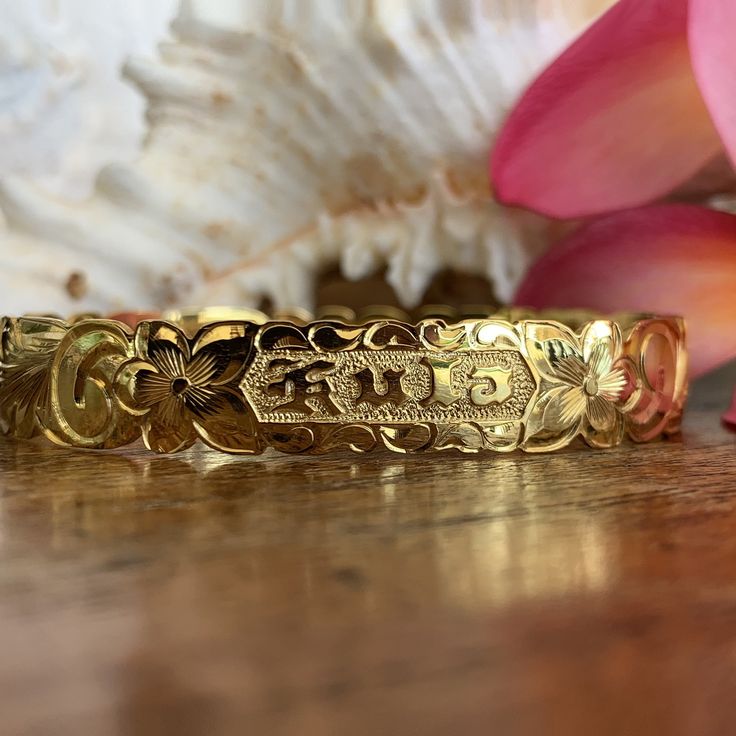 Locally Handmade. Please Allow 3-5 weeks for delivery. You will love and cherish these Custom Hawaiian Scroll Bangles. The Hawaiian Scroll Design is hand engraved by a local Master Engraver. Free Engraved Name in Black Enamel or Raised Gold lettering is included! It is beautiful, one-of-a-kind and custom made especially for YOU!! Our customers tell us these look just like the solid gold pieces they have - but we've made them affordable with 14K Gold Plating over .925 Sterling Silver. 10mm ~ $249 Traditional Ceremonial Jewelry With Engraving Option, Spiritual Engraved Wedding Bangle, Adjustable Etched Bracelets For Anniversary, Spiritual Engraved Bangle For Wedding, Spiritual Engraved Bangle For Weddings, Traditional Jewelry With Engraving Option For Gift, Traditional Engraved Jewelry As Gift, Traditional Jewelry With Engraving Option As Gift, Heirloom Adjustable Bracelets For Ceremonial Occasions