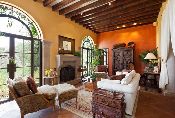 a living room filled with furniture and a fire place in the middle of an open floor plan