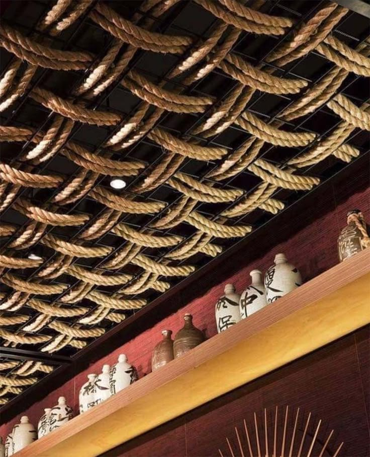 the ceiling is covered with rope and vases